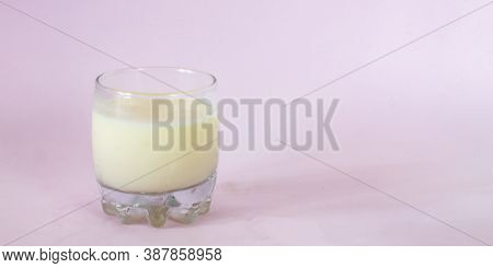 A Glass Of Milk And A Glass Jar Of Cornflakes