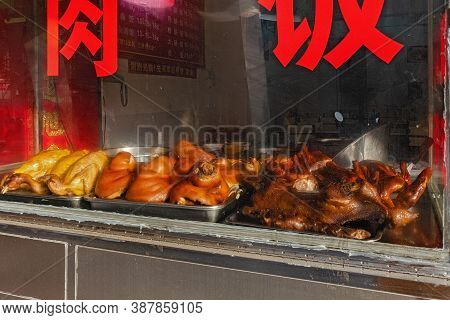 Showcase With Street Food In China.  Fried Meat On Counter In. Photo With Soft Focus.  China, Shenzh
