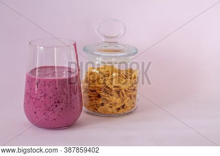 Smoothies Of Berries And Cornflakes On A Pink Background