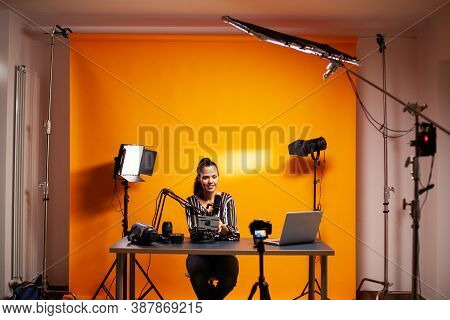 Videographer Showing Battery With V-mount In Home Studio For Podcast. Professional Videography Gear 