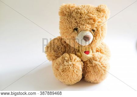 Soft Teddy Bear With Long Light Brown Fur And A Red Heart On A Scarf Around His Neck. Valentine\'s D