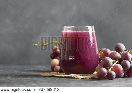 Glass Of Black Or Red Grape Fruit Compote Juice With Fresh Grapes, Organic Fruit Cold Drink Concept,