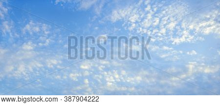 Beautiful Fluffy White Clouds In Blue Sky . Altocumulus Cloud Formation