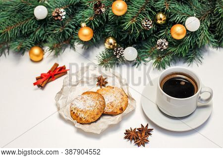 Christmas Layout With A Cup Of Coffee And Cookies On The Table, Gold Ornaments On Fir Branches. New 