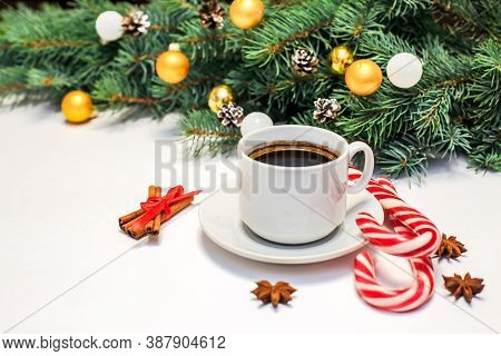 Christmas Layout With A Cup Of Coffee On The Table, Decorations, Fir Branches, Candy And Cinnamon. N