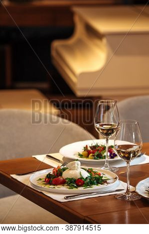 Restaurant Table Served With Spanish Buratta Tomato Salads