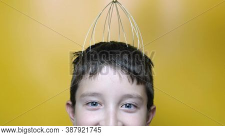A Caucasian Boy Enjoy Head Scalp Massage By Anti Stress Acupuncture Metal Octopus Tool, Equipment, S