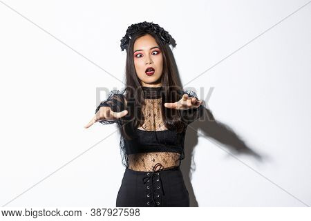 Image Of Funny And Beautiful Woman Acting Like Undead Widow, Wearing Black Lace Dress And Wreat, Loo