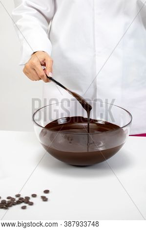 Closeup Female Chef Stirring And Pouring Dark Melted Chocolate Isolated On White Background. Chocola
