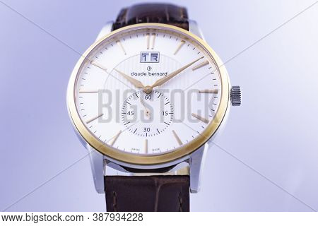Geneve, Switzerland 01.10.2020 - Claude Bernard Man Swiss Made Watch Gold Pvd Coating White Dial Lea
