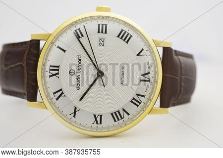 Geneve, Switzerland 01.10.2020 - Claude Bernard Man Swiss Made Watch Gold Pvd Coating White Dial Lea