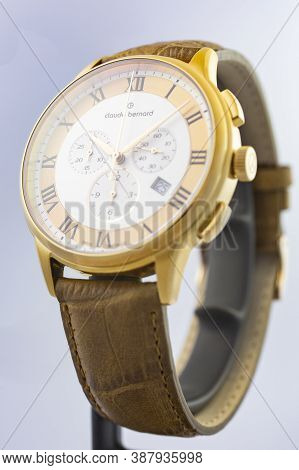 Geneve, Switzerland 01.10.2020 - Claude Bernard Man Swiss Made Watch Gold Pvd Coating Leather Strap 