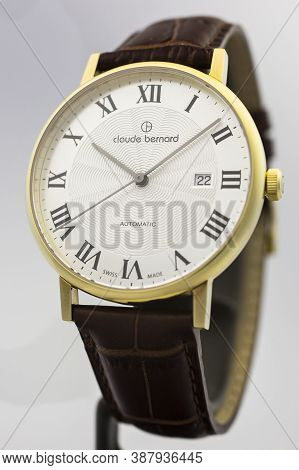 Geneve, Switzerland 01.10.2020 - Claude Bernard Man Swiss Made Watch Gold Pvd Coating White Dial Lea