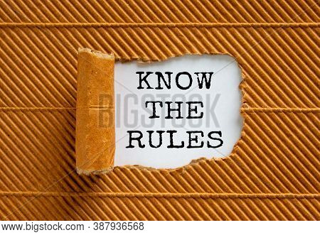 The Text 'know The Rules' Appearing Behind Torn Brown Paper. Beautiful Background. Business Concept.