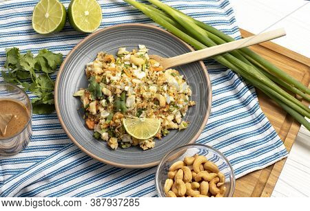 Crunchy Thai Peanut & Quinoa Salad, Lime, Green Onion Blue And Wood Background
