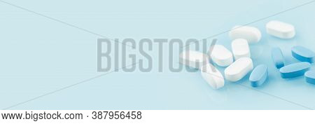 Medical Banner Of Many White And Blue Capsule Tablets Or Pills On The Table. Close Up Edgeless. Heal