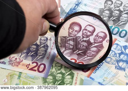 Ghanaian Cedi In A Magnifying Glass A Business Background