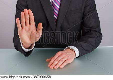 Close Up Businessman Showing Stop Gesture With Hand. Businessman Saying Stop Holding His Hand In Fro