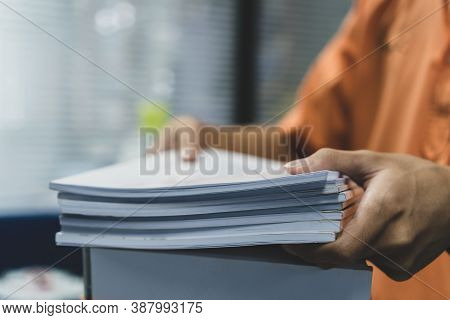 Office Workers Employee Holding Stacks Of Lot Documents Report Papers Waiting Be Managed On Desk In 