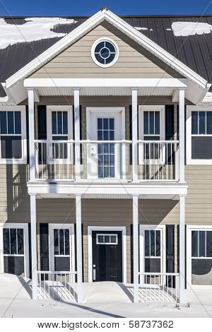 New townhouses under a layer of freshly fallen snow.