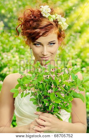 Beautiful smiling bride with chaming red hair. Wedding dress and accessories. Wedding decoration. 