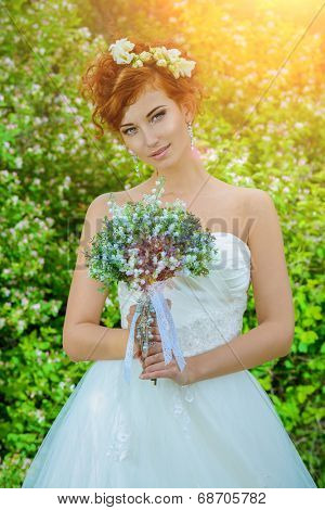 Beautiful smiling bride with chaming red hair. Wedding dress and accessories. Wedding decoration. 