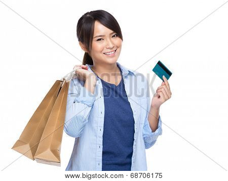 Asian young woman with shopping bag and credit card isolated on white background
