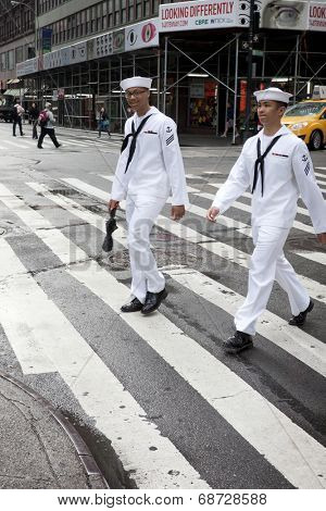 NEW YORK - MAY 23: Two US Navy sailors on liberty walk in midtown Manhattan near Times Square during Fleet Week NY on May 23, 2014.