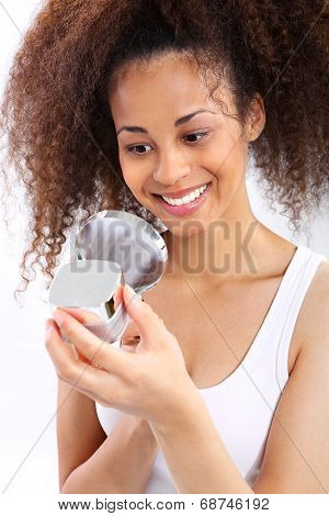 Dark skinned woman reads the face cream.