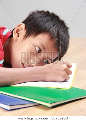 Young Boy Writing Something On The Book
