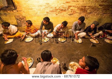 KATHMANDU, NEPAL - DEC 9, 2013: Unknown children during dinner at Jagadguru School. School established at 2013, to let new generation learn Sanskrit and preserve Hindu culture.