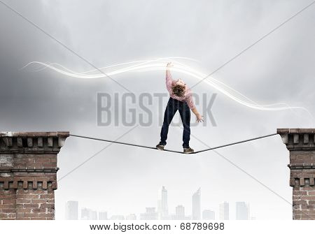 Young man in casual evading from flying icons