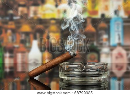 Smoking cigar in an ashtray