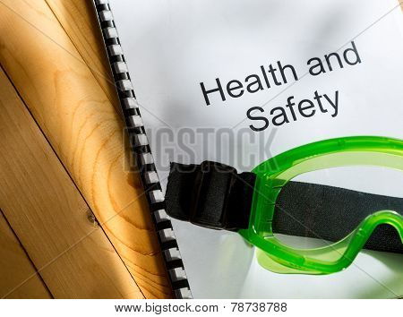 Register With Goggles On Wooden Background