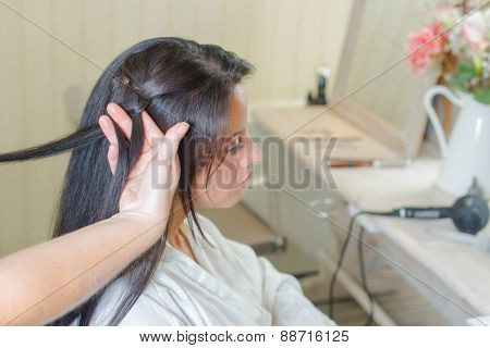 Brunette having her hair re-styled