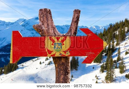 Montenegro Flag wooden sign with winter background