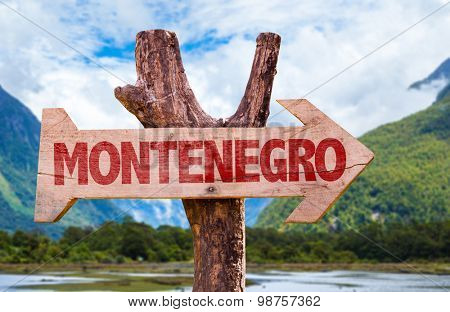 Montenegro wooden sign with mountains background