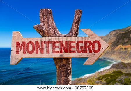 Montenegro wooden sign with coast background