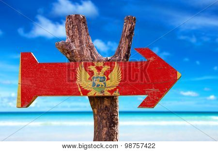 Montenegro Flag wooden sign with beach background