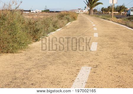 Dirt road. Off road, spring dry grass. Desert, palm ground stone way