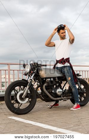 Brutal Man Near His Cafe Racer Custom Motorbike.