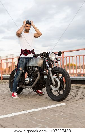 Brutal Man Near His Cafe Racer Custom Motorbike.