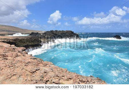 Waves crashing on to the bluffs beside Andicuri Beach in Aruba.