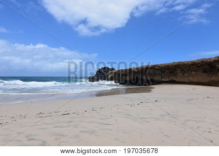 Pretty Andicuri Beach with white sand an a bluff.
