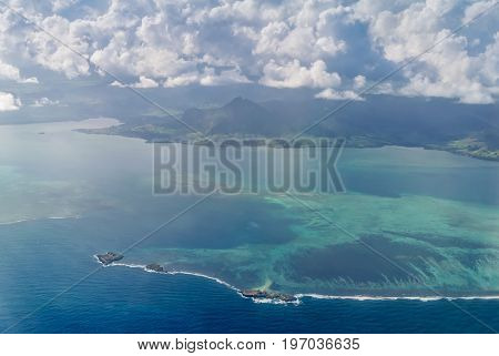Aerial picture of the southeast south east coast of Mauritius Island. Beautiful lagoon and reef barrier of Mauritius Island shot from above. Fouquets Island with a lighthouse in the foreground.