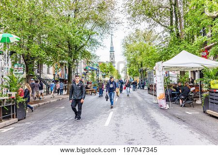 Montreal Canada - May 26 2017: People walking on Saint Denis street in Montreal's Plateau Mont Royal in Quebec region