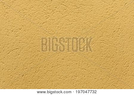 Yellow ochre painted stucco wall. Background texture.