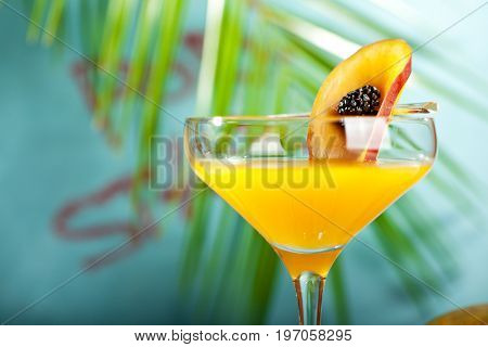 Summer  Cocktail -  Pornstar Martini. Drink with Passion fruit, Vodka, Liquor, Vanilla Syrup, Champagne and Lime Juice. Tropical Leaf on Background