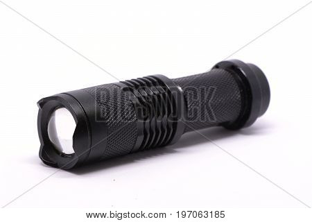 Isolated metal black flashlight on white background