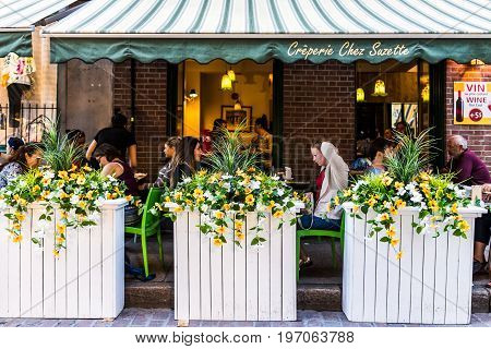 Montreal, Canada - May 27, 2017: Old Town Area With People Sitting By Street In Evening Outside Rest